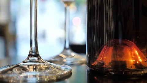 Two glasses of champagne and different colors bottles of wine exhibition in the Stock Footage 92307072