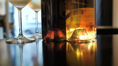 Two glasses of champagne and different colors bottles of wine exhibition in the Stock Footage 92307225