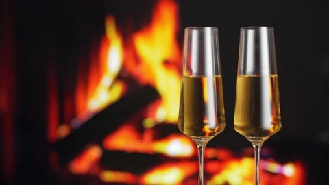 Two glasses of champagne are on the table, against of the fireplace. Stock Footage 145145074
