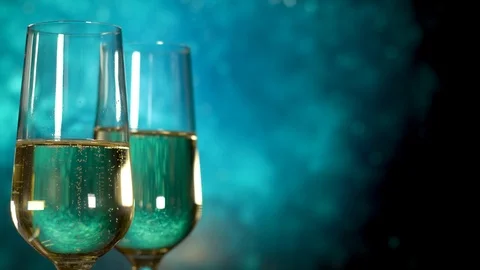 Two glasses of champagne with bubbles on blue background. Stock Footage 110924817
