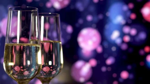 Two glasses of champagne with bubbles on blue blinking background. Stock Footage 111076719