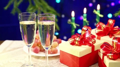 Two glasses of champagne with bubbles close-up against the background of a ta Stock Footage 83090857