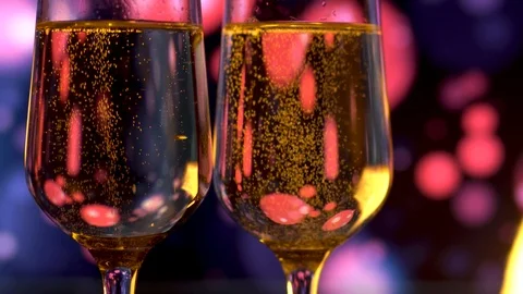 Two glasses of champagne with bubbles on dark blue blinking background. Stock Footage 111439382