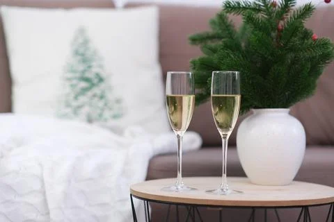 Two glasses of Champagne on caffee table in living room. Christmas home interior Stock Photos
