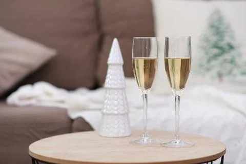 Two glasses of Champagne on caffee table in living room. Christmas home interior Stock Photos