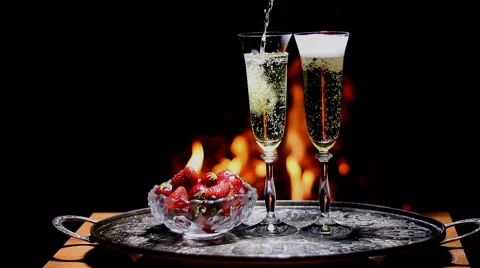 Two glasses of champagne with flame on background Video stock 63123402