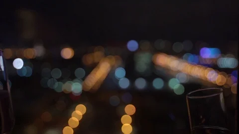Two glasses of champagne hit each other on background of multi-colored lights Stock Footage 122774872