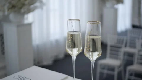 Two glasses of champagne on a light background. Stock Footage 262681055