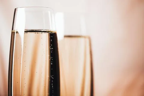 Two glasses of champagne on light background. Stock Photos