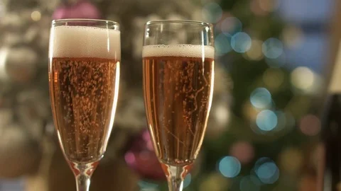 Two glasses of champagne standing on the table in the background of a blurred Stock Footage 83654667