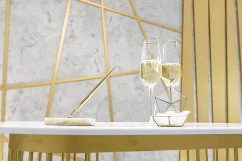 Two glasses of champagne on a white table Stock Photos