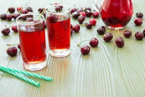 Two glasses of cherry juice and empty space. Stock Photos