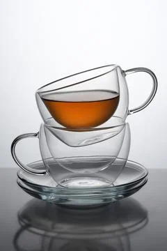 Two glasses for coffee or tea, standing on top of each other with tea in the Stock Photos