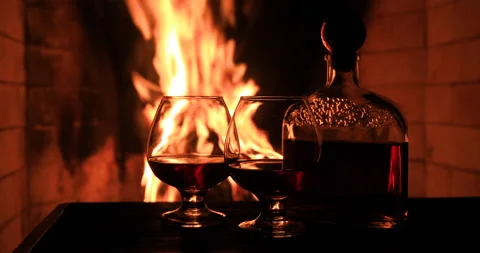 Two glasses of cognac and a bottle near the fireplace. Stock Footage 149126358