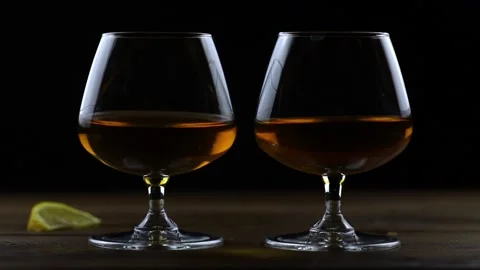 Two glasses of cognac Stock Footage 220932818