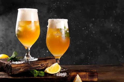 Two glasses of cold beer with lemon and mint, traditional latin american dr.. Stock Photos