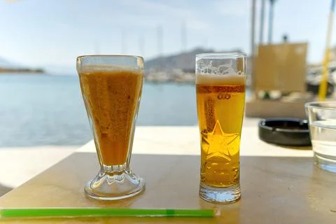Two glasses of cold beer on the table in luxury place with a sea view in summer Stock Photos