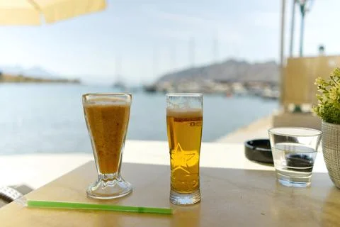 Two glasses of cold beer on the table in luxury place with a sea view in summer Stock Photos
