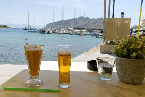 Two glasses of cold beer on the table in luxury place with a sea view in summer Stock Photos