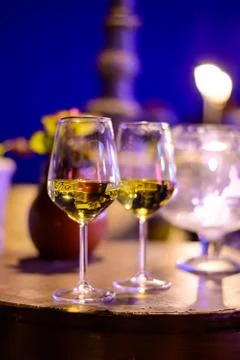 Two glasses of cold dry white wine served outdoor in cafe at night in Italy Stock Photos