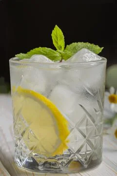 Two glasses of cold, refreshing lemonade. Mojito cocktail with lemon and mint Stock Photos
