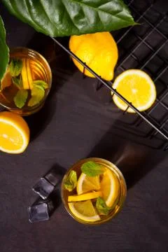 Two glasses of cold refreshment tea with ice and lemon fruit. Photos