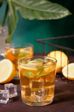Two glasses of cold refreshment tea with ice and lemon fruit. Stock Photos