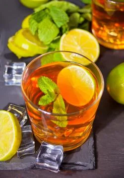 Two glasses of cold refreshment tea with ice and lemon fruit. Stock Photos