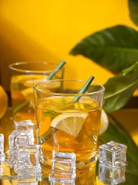 Two glasses of cold refreshment tea with ice and lemon fruit. Fotos Stock