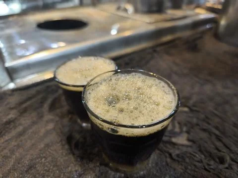 Two glasses of dark beer. Photos