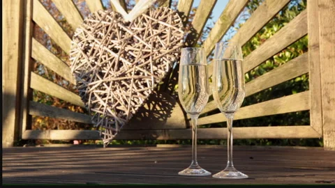 Two glasses on decking floor at sunset Stock Footage 133815357