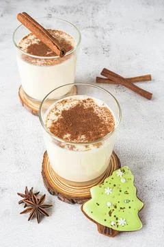 Two glasses of egg-nog on grey background Stock Photos