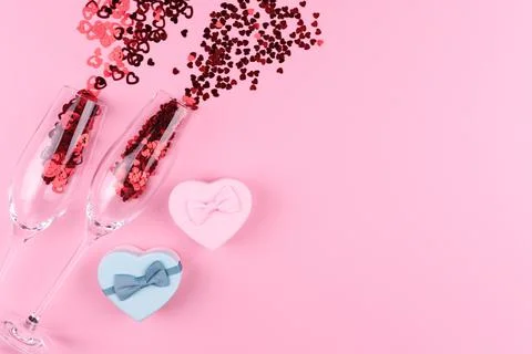 Two glasses filled with heart sequins with a bottle of champagne and a Valent Stock Photos