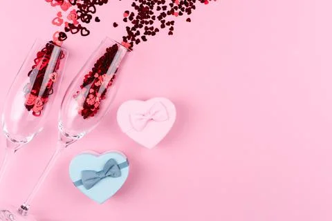 Two glasses filled with heart sequins with a bottle of champagne and a Valent Stock Photos