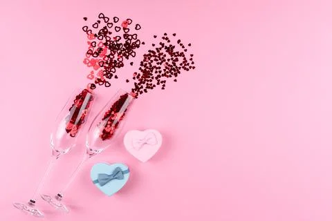 Two glasses filled with heart sequins with a bottle of champagne and a Valent Stock Photos
