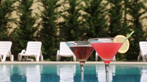 Two Glasses Filled With A Summer Drink In The Summer Heat Near The Pool Видео 84653061