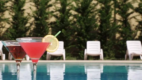Two Glasses Filled With A Summer Drink In The Summer Heat Near The Pool Stock Footage 84653067