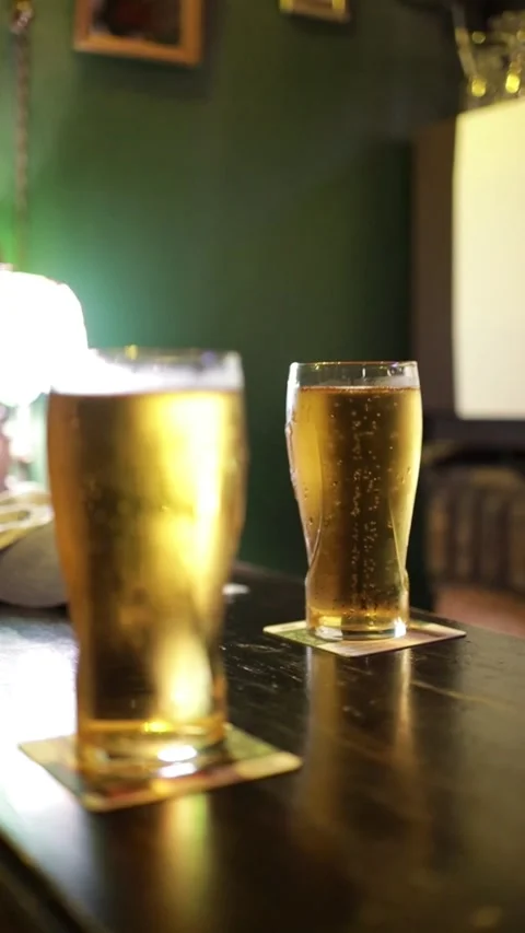 Two Glasses of Fresh Beer With Focus Shift Stock Footage 323937545