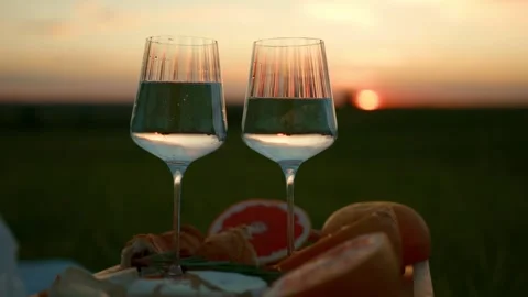 Two Glasses with Fresh Fruit at Romantic Sunset Stock Footage 339111278