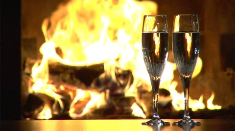 Two glasses in front of fireplace Vídeos de archivo 35571232