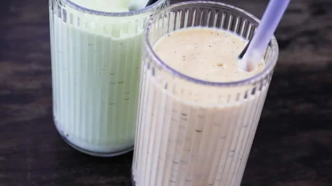 Two glasses of fruit milkshakes. Video stock 276461547