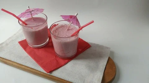Two glasses fruit smoothies milkshake assembly Stock Footage 109497140