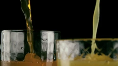 Two glasses full of juice and soda. Slow motion Stock Footage 75990165
