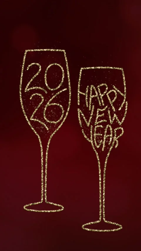 Two glasses with gold particles and the text 2026 and Happy New Year on a red Stock Footage 321655837