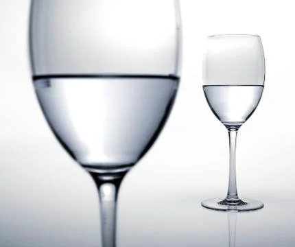 Two glasses half filled of water. Stock Illustration