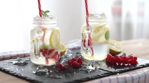 Two glasses of homemade lemonade, refreshing summer detox drink made of lemon Stock Footage 66377735