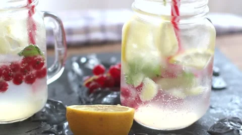 Two glasses of homemade lemonade, refreshing summer detox drink made of lemon Stock Footage 66377750