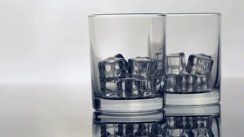 Two glasses of ice filled with whiskey Stock-Footage 97781232