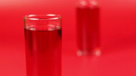 Two glasses of juice on red background Stock Footage 63982339