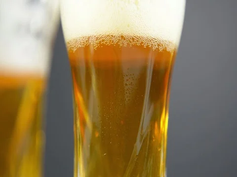 Two glasses with light craft beer in a bar on a dark background. bubbles rise. Stock Footage 121251372